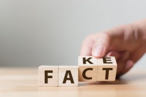 facts versus fakes illustration with wood blocks