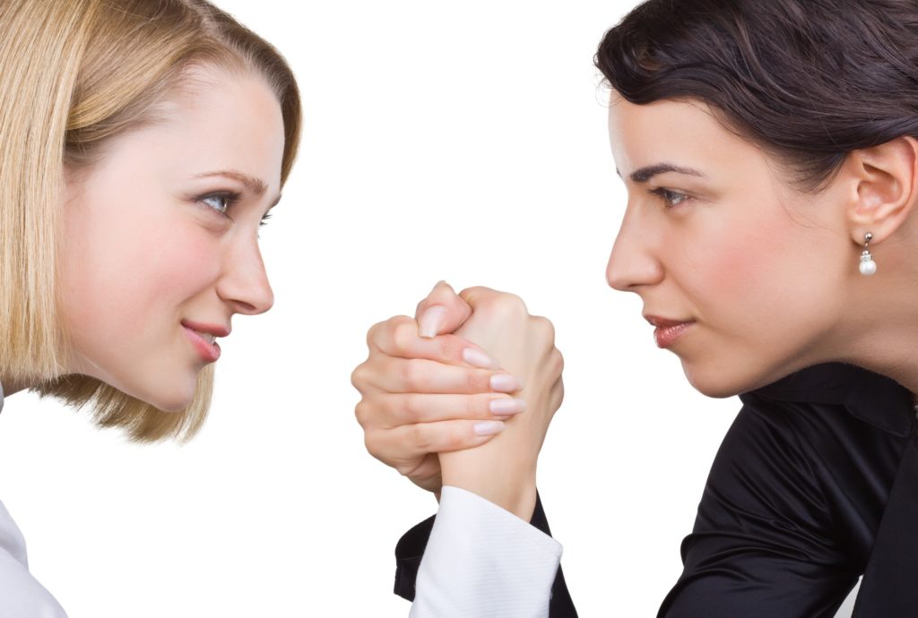 Two women arm wrestling