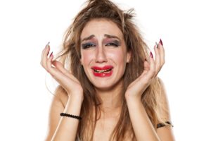 Upset woman crying with smeared makeup